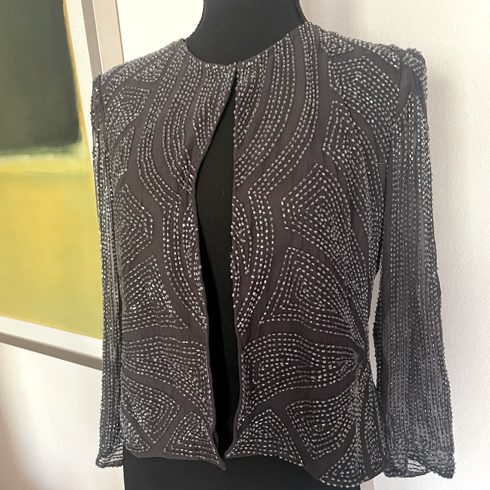 Beaded silk coat with eye hook closure at the collar